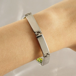 Detail of silver titanium steel rectangular link bracelet on a model wrist for a modern look