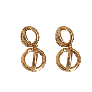 Minimalist gold double circle hoop earrings with polished metallic finish on white background