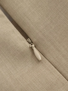 Detail of hidden zipper and fine woven khaki fabric texture on women's dress