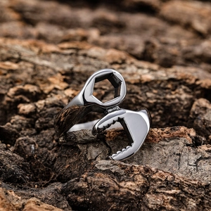 Vintage stainless steel wrench shaped ring for men and women on a natural wood background