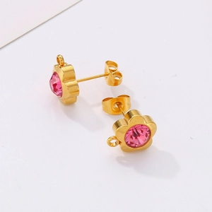Detail of flower shaped gold stud earrings with pink gemstone and small DIY loop