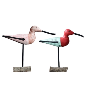 Pair of Nordic style hand-painted wooden bird ornaments on rustic natural wood bases