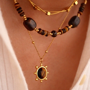 Layered 14K gold plated necklaces set with tiger eye stones and sun star pendant