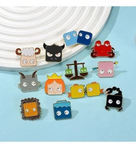 Macro display of 12 cartoon metal enamel pins showing zodiac animal signs and vibrant colors