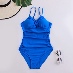 Detail of royal blue one-piece swimsuit featuring ruched tummy control and cross pleated cups