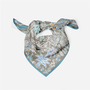 Detail of hand-painted floral silk scarf in grey with blue and orange leaf patterns