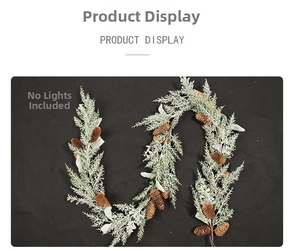 Detailed view of snowy Christmas garland featuring pine cones and frosted green leaves