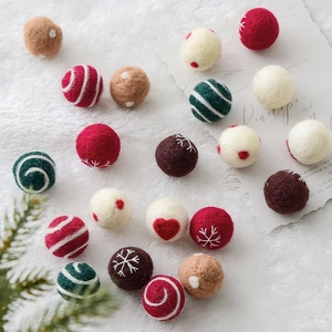 Handmade 3cm wool felt Christmas balls with embroidered snowflakes and hearts on plush background