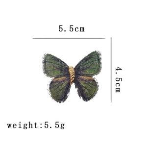 Detail showing dimensions of 5.5cm by 4.5cm for the embroidered butterfly brooch