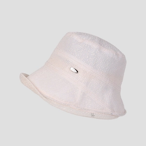Close-up of off-white woven lace sun hat featuring a metallic brand tag detail