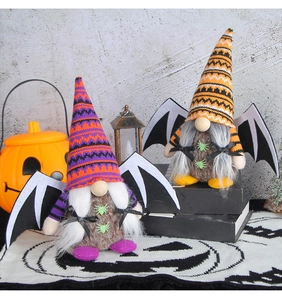 Detail of Halloween gnome plush dolls with bat wings and spider accents in festive setting