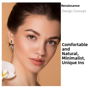 Detail of olive green teardrop earrings with crystals worn on a model's ear