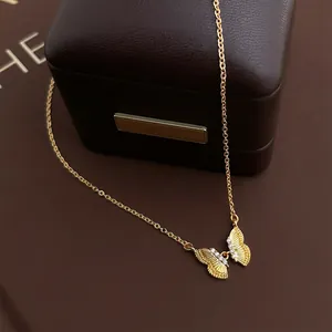 French luxury style butterfly necklace with zircons and 18K gold plating on a jewelry box