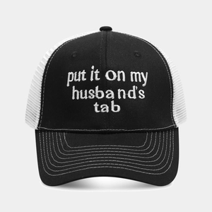 Detailed front view of a black and white trucker hat with white letter embroidery