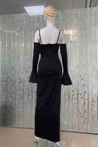Back view of black bodycon evening dress with halter straps and flared sleeve detail