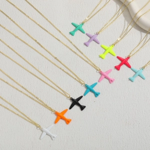 Close-up of colorful airplane pendants in multiple shades with gold-colored chains