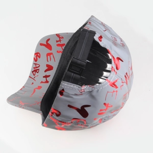 Detail of grey baseball cap with red graffiti pattern and adjustable plastic buckle