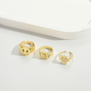 Vintage gold adjustable rings set featuring alien, star, and letter designs with crystals