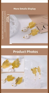 Detailed macro view of golden leaf texture and white natural pearl on elegant earring