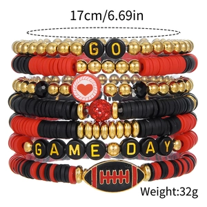 Detail of layered football themed bracelets with clay beads and GAME DAY letter beads