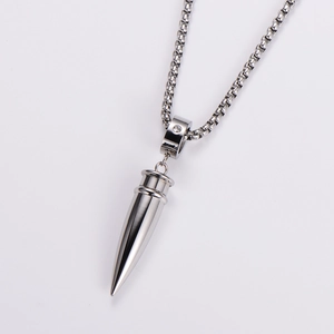 Macro view of silver bullet pendant with polished stainless steel finish and small diamond