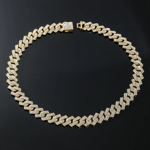 Close-up of gold iced-out Cuban link chain featuring shiny pavé crystals and square clasp