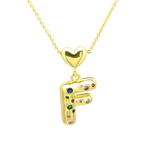 Macro detail of gold letter F pendant with colorful zircons and heart connection