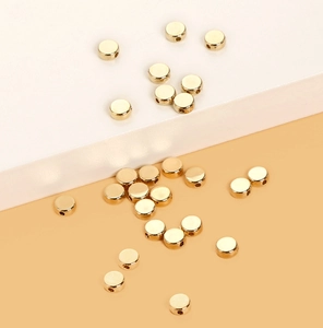 Detailed view of flat round golden CCB spacer beads with holes for DIY jewelry making