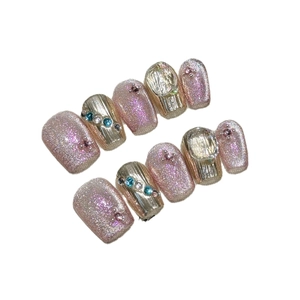 Pink cat eye press-on nails set with glitter and gold mirror accents and rhinestones