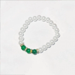 Elegant white faux pearl necklace with green gemstone accents and gold spacers