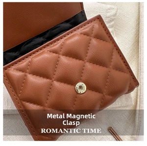 Detail of brown quilted leather bag featuring a gold magnetic closure and diamond texture
