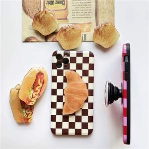 3D food-shaped bread phone socket holder on checkered case with a croissant design