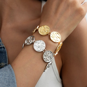 Minimalist double-sided textured coin bracelet in gold and silver finish on model