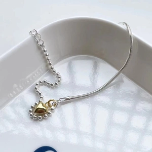 Minimalist S925 silver mixed chain bracelet featuring a golden heart pendant