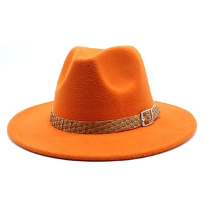 Close-up of bright orange felt fedora with brown braided band and silver buckle