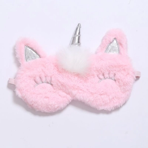 Detailed close-up of pink plush unicorn sleep mask with soft texture and elastic strap