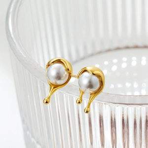 18K gold plated pearl earrings with melting water drop design on a glass rim