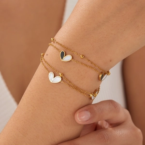 Double-layered gold-plated stainless steel chain bracelet with black and white heart charms