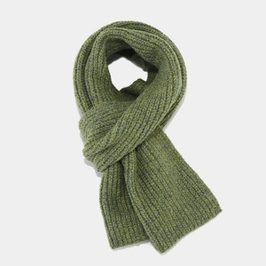 Close-up of grass green thick knit scarf with vertical ribbed texture for winter warmth