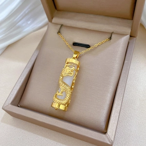 Golden dragon cylinder necklace with white stone insert in luxury jewelry box