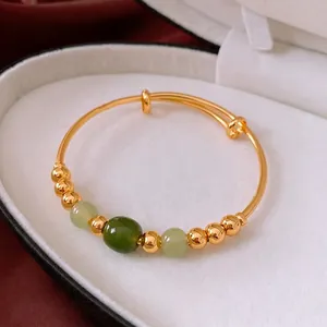 18k gold plated adjustable bangle with green jade beads in a luxury display case
