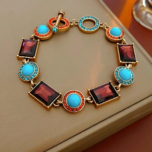 Detailed macro view of vintage gold bracelet with colorful gems and T-bar clasp