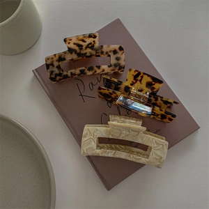 French vintage leopard print and marble acetate claw clips on a magazine