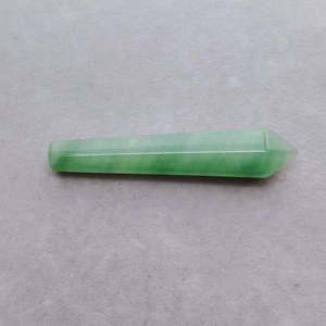 Macro detail of a polished green quartz crystal pillar with a hexagonal pointed tip