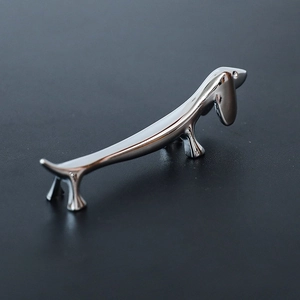 Polished silver dachshund-shaped metal chopstick rest with a shiny mirror finish