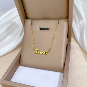 Minimalist gold titanium steel necklace with 'Forever' cursive pendant in a beige gift box