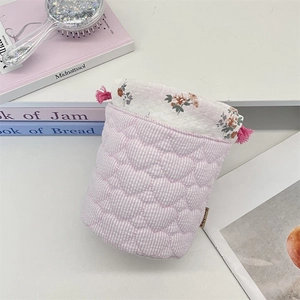 Detail of drawstring storage bag with heart quilted fabric and floral inner lining