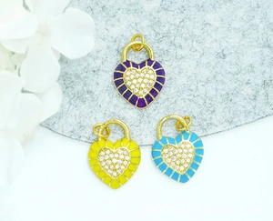Macro detail of 18K gold plated heart lock pendants with colorful enamel and pave zircon