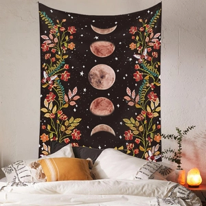 Detail of bohemian moon phase tapestry with floral patterns over a bedroom setup