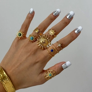 Bohemian gold ring set with sun and star motifs featuring turquoise and blue stones